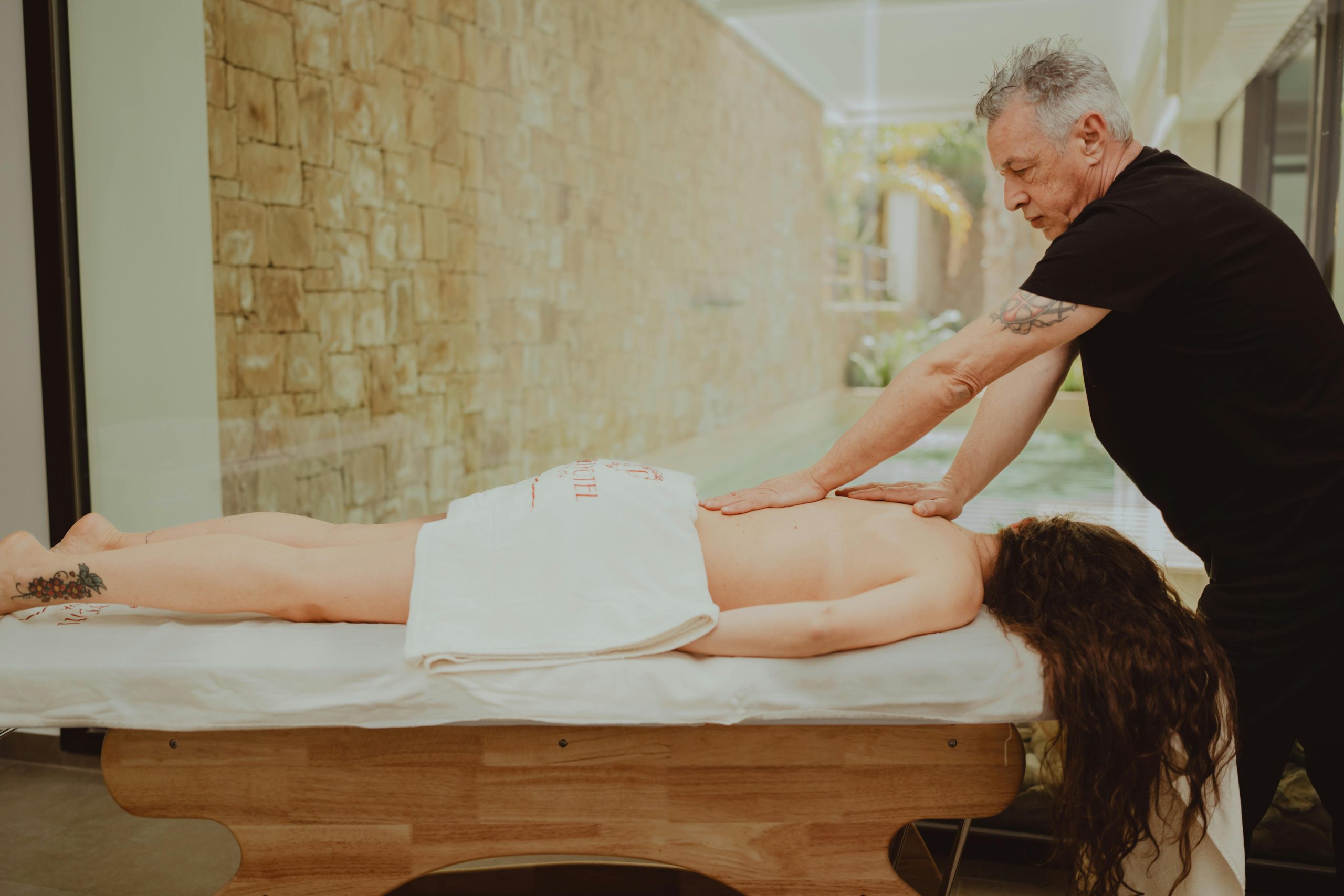 Professional massage therapist performing a relaxing spa treatment in a serene setting.